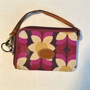 Fossil wristlet in water resistant coated canvas with leather trim and strap.